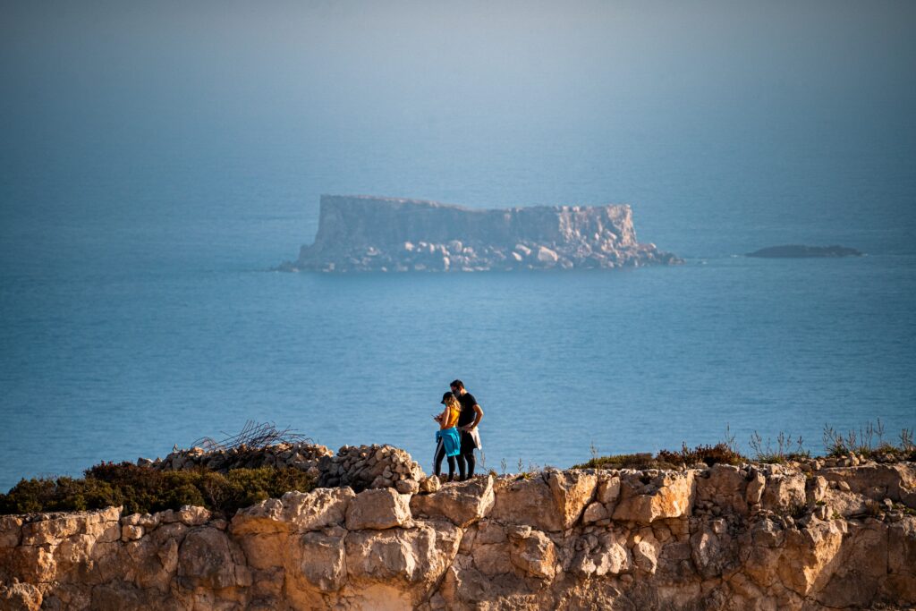 A view of neighbouring islands from Gozo's rocky coastline.